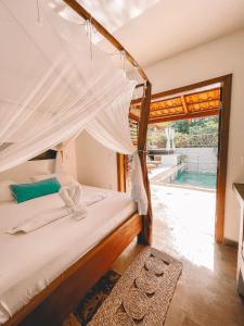 a bedroom with a bed with a canopy at Pousada Fortal Preá in Prea