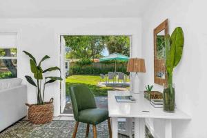 a white desk and chair in a room with a patio at Tropical Oasis 3 Bedroom House with Hot Tub West Palm Beach in West Palm Beach