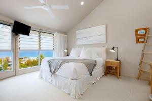 a bedroom with a bed with a view of the ocean at Unit 9 Fantastic Holiday Apartment in Sunshine Beach Stunning Views Opposite Beach Access in Sunshine Beach