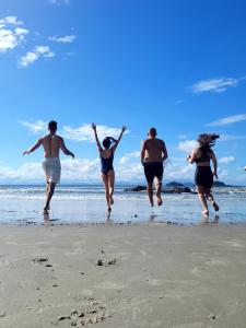 a group of people running on the beach at Social Hostel Café e Bar in Curitiba