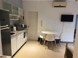 uma cozinha com uma mesa e cadeiras numa cozinha em Departamento céntrico con cochera - Corrientes Capital em Corrientes