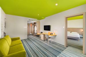 A bed or beds in a room at Park Inn By Radisson Zalakaros Hotel & Spa