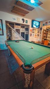 a billiard table in a room with afits at Social Hostel Café e Bar in Curitiba