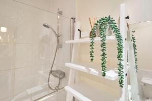 a bathroom with a shower and a shelf with a plant at Host & Stay - Nunnery Fields in Canterbury