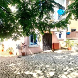 a building with a gate and a cobblestone street at Ace shortlet apartment in Abuja