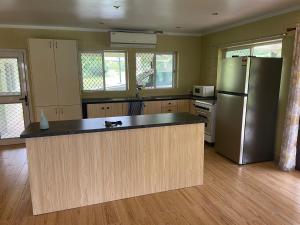 a kitchen with a refrigerator and a counter top at Aunty Fou's Home - Vaivase in Apia