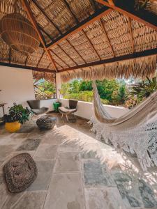 a room with a hammock in a resort at Pousada Fortal Preá in Prea