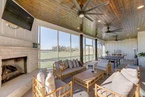 a living room with a couch and a fireplace at Texas Farmhouse on 5 Acres Patio and Grill! in Manor