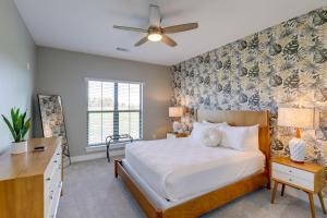 a bedroom with a bed and a desk at Texas Farmhouse on 5 Acres Patio and Grill! in Manor