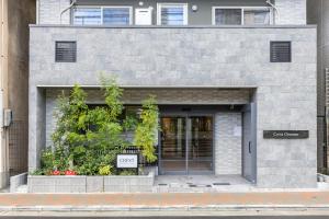 a facade of a building with a door at Crest Otemae Stay - Self Check-In Only in Osaka