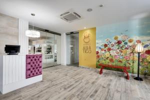 a store lobby with a bench and a wall with flowers at Barceló Teguise Beach - Adults Only in Costa Teguise