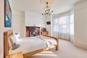a bedroom with a bed and a chandelier at Host & Stay - Bellevue Road in Ramsgate
