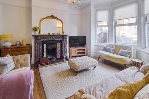 a living room with a fireplace and a mirror at Host & Stay - Bellevue Road in Ramsgate