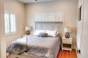 a bedroom with a large bed with two lamps at Oceanfront Family Retreat - Views, Wi-fi & A/C in Kaaawa