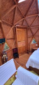 an attic room with a bed and two chairs at NG Glamping a 20 min de Neiva in Neiva