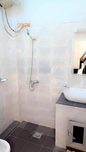 a bathroom with a shower and a sink and a toilet at Salam in Dakar