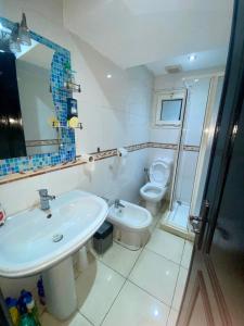 a bathroom with a sink and a toilet at Appartement de lux in Casablanca