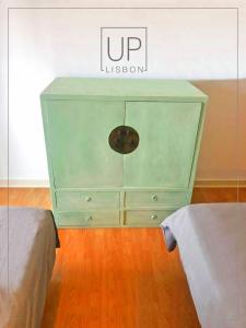 a green dresser with a sign on top of it at SIX by UP Lisbon I Your home away from home in Lisbon
