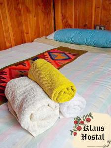 two beds with pillows on top of them at Hostal Klaus in Pucón
