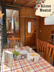 a table with a plate of food on top of it at Hostal Klaus in Pucón