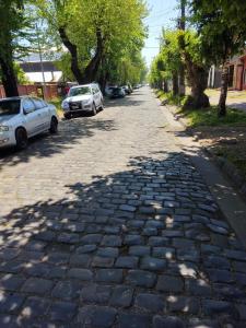 a cobblestone street with cars parked on it at Hostal NFrocket in Los Ángeles