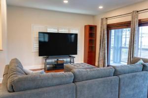 a living room with a couch and a flat screen tv at Oceanfront Family Retreat - Views, A/C & Wi-Fi in Kaaawa