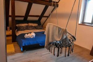 a swing in a bedroom with a bed at Family friendly house with a parking space Brestova Draga, Gorski kotar - 21977 in Delnice