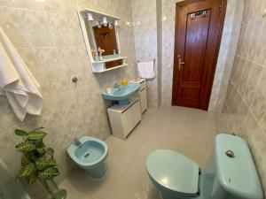 a bathroom with a blue toilet and a sink at -.Villa Nena 2.0.- in Ledesma