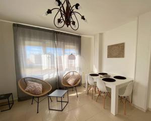 a dining room with a white table and chairs at -.Villa Nena 2.0.- in Ledesma