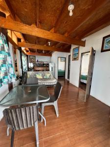 a living room with a table and chairs and a bed at Pocitas Casa Hotel - Playa & Piscina in Máncora