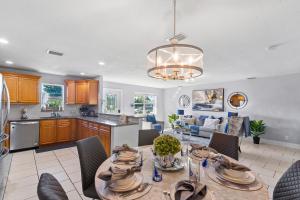 a kitchen and living room with a table and chairs at Luxe 4br Escape Pet-friendly Outdoor Lounge in West Palm Beach