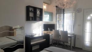 a kitchen and dining room with a table and chairs at Family friendly apartments with a swimming pool Lovran, Opatija - 14178 in Lovran