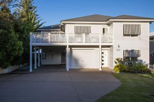 a white house with a balcony and a garage at Kalinda in Mollymook +17 photos