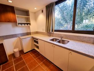a kitchen with a sink and a large window at Hotel boutique Tramas Andinas in Salta