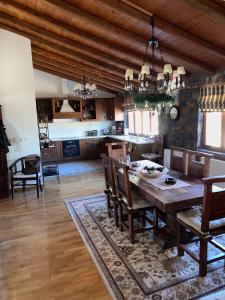 a dining room and kitchen with a table and chairs at πετρινο σαλε in Palaios Agios Athanasios