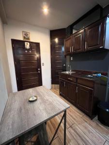 a kitchen with wooden cabinets and a table in it at Edificio G4 in Guatemala
