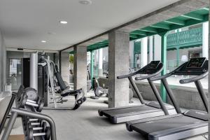 a gym with a row of treadmills and machines at Barceló Teguise Beach - Adults Only in Costa Teguise