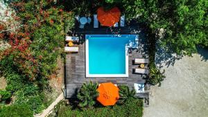 an overhead view of a swimming pool with orange umbrellas at Hotel Playa Scondida in Baru