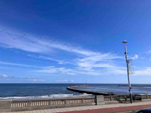 a beach with a pier and the ocean with a street light at WiFi Free Secure Parking Stadium & City Centre in Sunderland