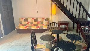 a room with a glass table and chairs and a couch at Cancún Suites Apartments - Hotel Zone in Cancún