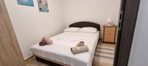 a small bedroom with a bed with white sheets at Mirjana Gajac in Gajac