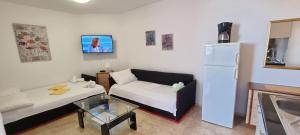 a living room with a couch and a refrigerator at Mirjana Gajac in Gajac