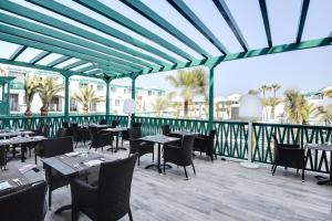 a restaurant with tables and chairs on a patio at Barceló Teguise Beach - Adults Only in Costa Teguise
