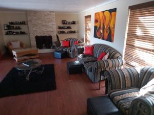 a living room with two couches and a fireplace at PHAT Joe's Accommodation in Cape Town