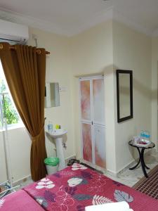 a bathroom with a toilet and a sink in a room at Heal Inn Roomstay - Islam Guest in Kangar