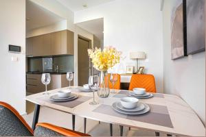 a dining room with a table with chairs and a kitchen at Westgate Apartment- 2N House in Ho Chi Minh City