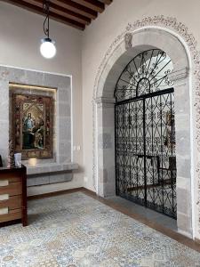 an ornate iron gate in a room with a fireplace at Hotel Cantera Real, Morelia in Morelia