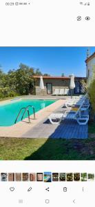 una foto de una piscina con sillas y sombrillas en 4 bedrooms house with shared pool enclosed garden and wifi at Covelas Povoa de Lanhoso, en Póvoa de Lanhoso