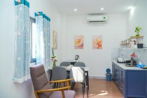 a kitchen with a table and chairs in a room at Palas House in Ho Chi Minh City