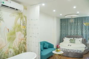 a bedroom with a bed and a blue couch at Palas House in Ho Chi Minh City